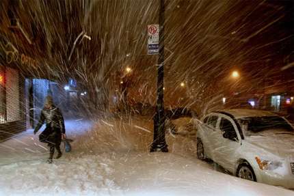 A pedestrian walks along 72nd Street in New York Sunday, Dec. 26, 2010, in the midst of a blizzard that hammered New York and much of the Northeast.