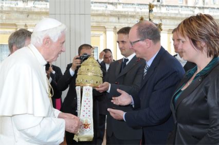 Pope Benedict XVI is presented with a tiara or papal crown