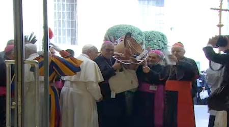 Clergy carry pagan canoe