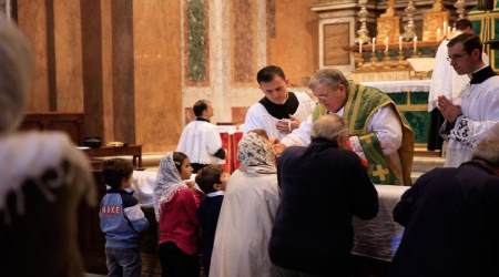 Cardinal Raymond Burke distributes Holy Communion at a traditional Latin Mass in Rome after a LifeSiteNews and Voice of the Family conference (October 2018).