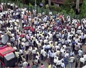 Brokers mill outside the Bombay Stock Exchange after trading was haulted.