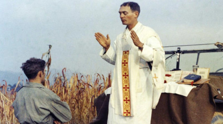 Fr. Emil Kapaun conducts a Korean War battlefield Mass improvising a Jeep hood as an altar